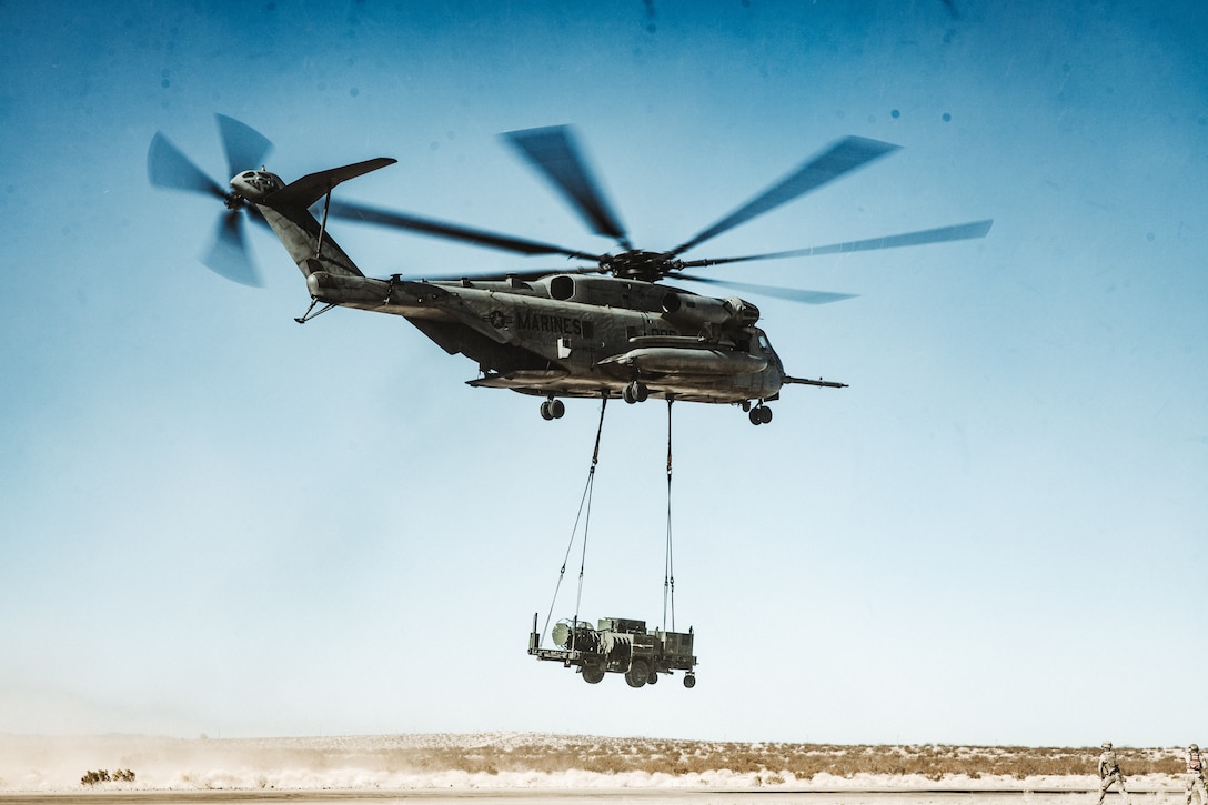 A U.S. Marine Corps CH-53E Super Stallion assigned to Heavy Helicopter Squadron 361, Marine Aircraft Group 16, 3rd Marine Aircraft Wing, lifts a Medium Range Air Defense Radar for the first time during an external lift certification as part of Service Level Training Exercise 4-25 at Marine Corps Air Ground Combat Center, Twentynine Palms, California, July 30, 2025. The purpose of SLTE 4-25 is to create a challenging, realistic training environment that produces combat-ready forces capable of operating as an integrated Marine Air Ground Task Force. (U.S. Marine Corps photo by Lance Cpl. Richard PerezGarcia)