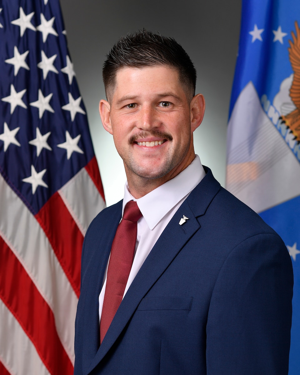 A civilian stands for a portrait.
