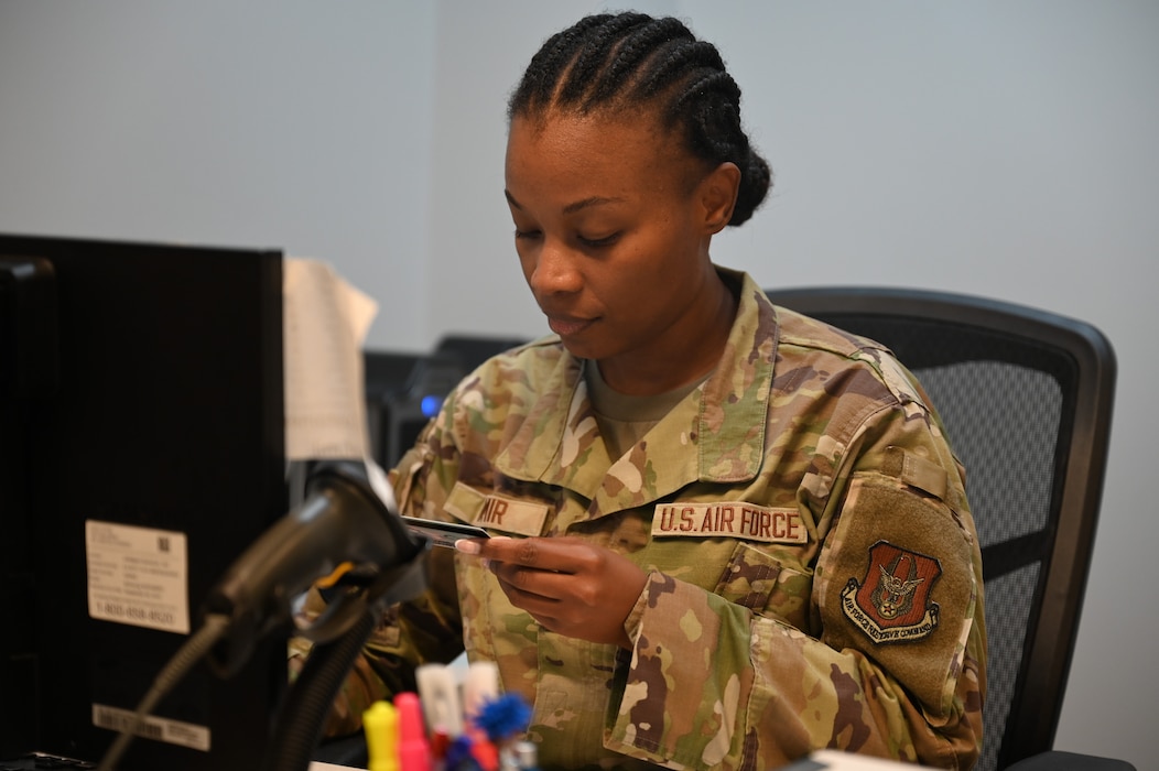 U.S. Air Force Airman Lorwy Valmir, 445th Force Support Squadron personnel specialist, verifies a customer’s identification before issuing a dependent ID at Wright-Patterson Air Force Base, Ohio, July 17, 2025. Dependents must keep their IDs current to retain access to base. (U.S. Air Force photo by Staff Sgt. Johnathan Quiñones)