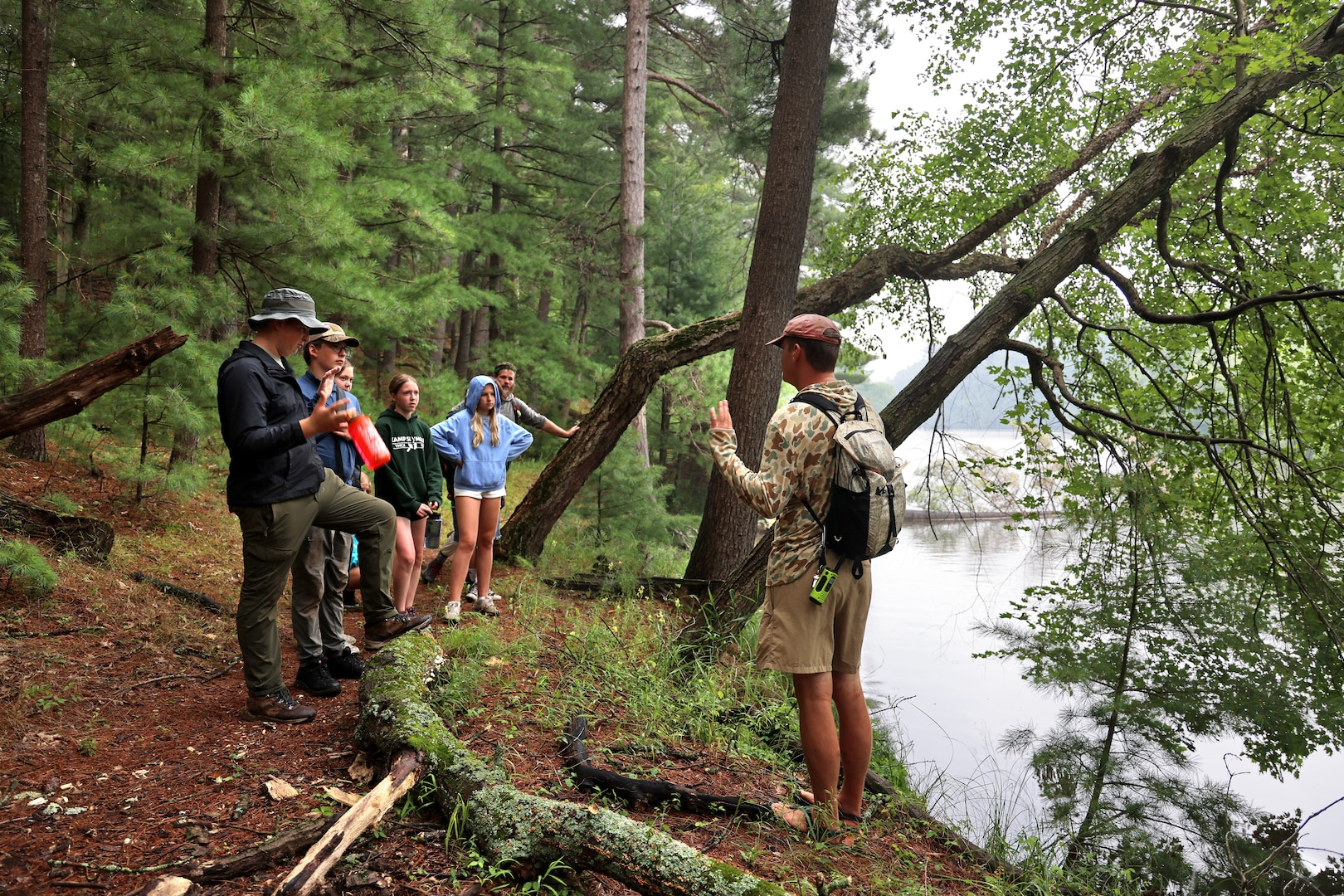 Mark Helminski, right, outdoor educator for the University of Wisconsin's Upham Woods Outdoor Education Center speaks to a group of Wisconsin National Guard youth while hiking on Blackhawk Island in Jefferson County, Wisconsin, July 30, 2025, during the Wisconsin National Guard's Epic Journey High Adventure Camp. The four day, three night Wisconsin River excursion hosted by the organization’s Joint Wellness & Resilience Directorate provided an opportunity for the youth to sharpen their canoeing and camping skills while focusing on personal resilience techniques. (U.S. National Guard photo by Paul Gorman)