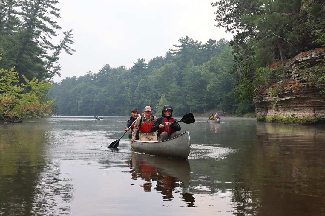 Mark Helminski, center, outdoor educator for the University of Wisconsin's Upham Woods Outdoor Education Center accompanies Wisconsin National Guard youth as they canoe up a segment of the Wisconsin River in Jefferson County, Wisconsin, July 30, 2025, during the Wisconsin National Guard's Epic Journey High Adventure Camp. The four day, three night Wisconsin River excursion hosted by the organization’s Joint Wellness & Resilience Directorate provided an opportunity for the youth to sharpen their canoeing and camping skills while focusing on personal resilience techniques. (U.S. National Guard photo by Paul Gorman)