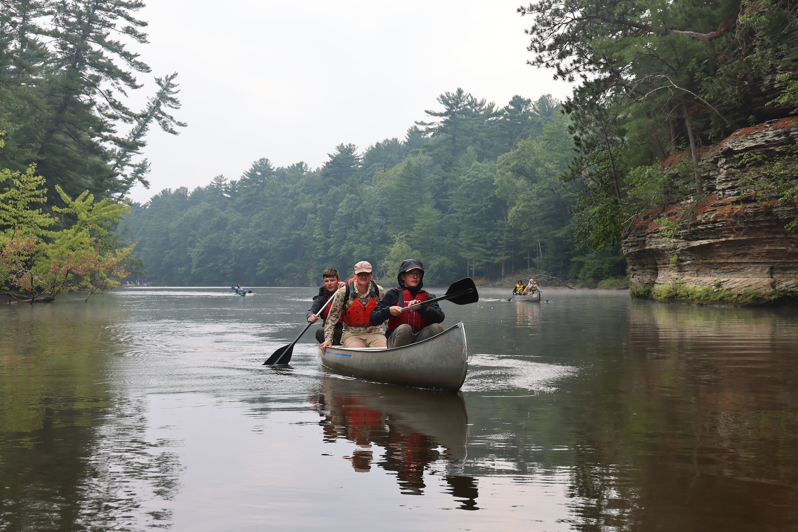 Mark Helminski, center, outdoor educator for the University of Wisconsin's Upham Woods Outdoor Education Center accompanies Wisconsin National Guard youth as they canoe up a segment of the Wisconsin River in Jefferson County, Wisconsin, July 30, 2025, during the Wisconsin National Guard's Epic Journey High Adventure Camp. The four day, three night Wisconsin River excursion hosted by the organization’s Joint Wellness & Resilience Directorate provided an opportunity for the youth to sharpen their canoeing and camping skills while focusing on personal resilience techniques. (U.S. National Guard photo by Paul Gorman)