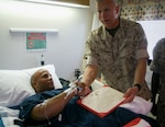 U.S. Marine Corps Sgt. Carlos Evans receives the Purple Heart in 2010, presented by the 34th Commandant of the U.S. Marine Corps Gen. James Conway at Walter Reed. August is Purple Heart Month, and Aug. 7 is observed as Purple Heart Day. Gen. George Washington, then commander in chief of the Continental Army, established what became the Purple Heart on Aug. 7, 1782, at Newburgh, New York.