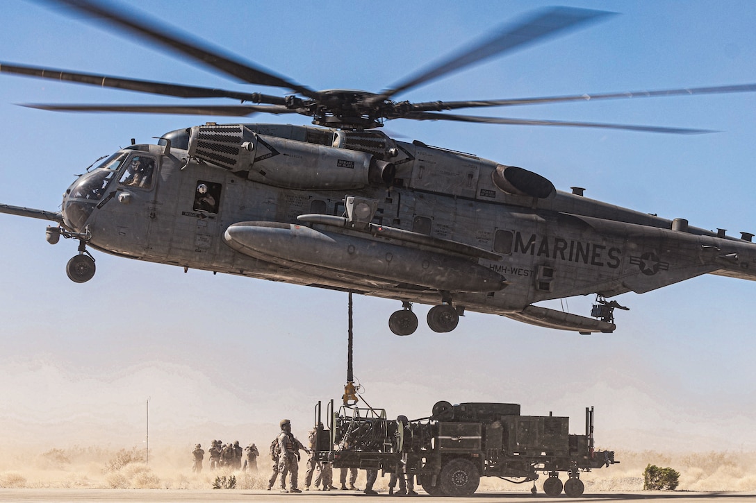 U.S. Marines with Combat Logistics Battalion 8, Combat Logistics Regiment 2, 2nd Marine Logistics Group and Marine Heavy Helicopter Squadron (HMH) 361, Marine Aircraft Group 16, 3rd Marine Air Wing, conduct a helicopter support team operation for the first evaluation of the air transportability of the Medium Range Air Defense Radar during Service Level Training Exercise 4-25 at the Marine Corps Air-Ground Combat Center, Twentynine Palms, California, July 30, 2025. SLTE 4-25 is designed to be a challenging, realistic training environment that produces combat-ready forces capable of operating as an integrated Marine Air Ground Task Force across all domains of military operations. (U.S. Marine Corps photo by Lance Cpl. Judith Ann Lazaro)