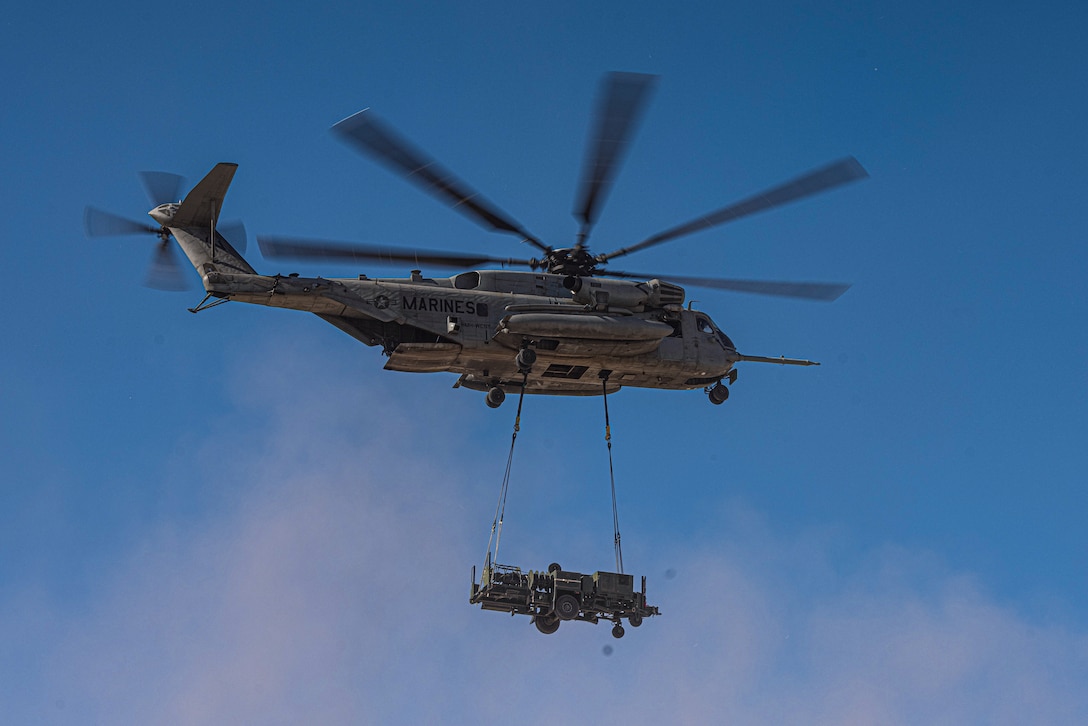 U.S. Marines with Combat Logistics Battalion 8, Combat Logistics Regiment 2, 2nd Marine Logistics Group and Marine Heavy Helicopter Squadron (HMH) 361, Marine Aircraft Group 16, 3rd Marine Air Wing, conduct a helicopter support team operation for the first evaluation of the air transportability of the Medium Range Air Defense Radar during Service Level Training Exercise 4-25 at the Marine Corps Air-Ground Combat Center, Twentynine Palms, California, July 30, 2025. SLTE 4-25 is designed to be a challenging, realistic training environment that produces combat-ready forces capable of operating as an integrated Marine Air Ground Task Force across all domains of military operations. (U.S. Marine Corps photo by Lance Cpl. Judith Ann Lazaro)