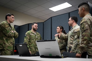 U.S. Airmen and U.S. Soldiers from the Joint Communications Support Element, MacDill Air Force Base, Florida, and Royal New Zealand Air Force personnel discuss best practices for military communications at Andersen Air Force Base, Guam, during the Air Force’s 2025 Department-Level Exercise series, July 14, 2025. JCSE’s ability to deploy quickly and operate with minimal equipment allows it to deliver secure, reliable communications support promptly. The DLE encompasses all branches of the Department of Defense, Allies, and partners, employing over 400 joint and coalition aircraft and more than 12,000 personnel across more than 50 locations spanning 3,000 miles. (U.S. Air Force photo by Staff Sgt. Dalton Williams)