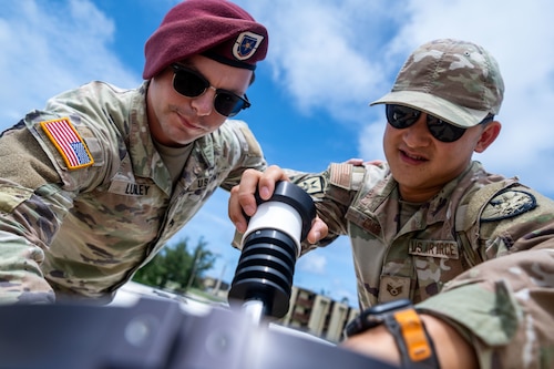 U.S. Army Staff Sgt. Michael Lumley, an information technology specialist assigned to the Joint Communications Support Element, MacDill Air Force Base, Florida, and U.S. Air Force Staff Sgt. Andrew Choe, JCSE expeditionary communicator, assemble a Hawkeye 360 satellite during the Air Force’s 2025 Department-Level Exercise series at Andersen Air Force Base, Guam, July 13, 2025. More than 40 JCSE personnel deployed to the Indo-Pacific area of responsibility to provide expeditionary communications support to Air Mobility Command, U.S. Transportation Command, and their Allies and partners. The DLE encompasses all branches of the Department of Defense, Allies, and partners, employing over 400 joint and coalition aircraft and more than 12,000 personnel across more than 50 locations spanning 3,000 miles. (U.S. Air Force photo by Senior Airman Zachary Foster)
