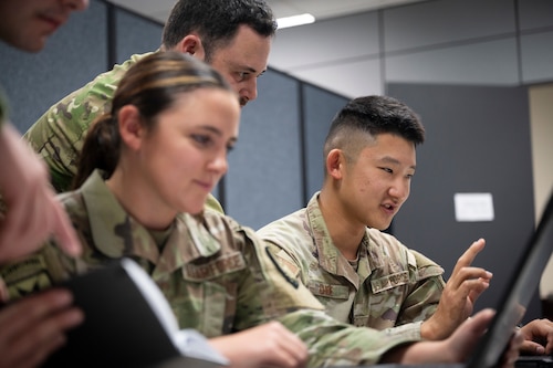 From left, U.S. Air Force Staff Sgt. Karlie Rogers, an expeditionary communicator assigned to the Joint Communications Support Element, MacDill Air Force Base, Florida, Flight Sergeant Tim Clark, Royal New Zealand Air Force 230th Squadron Tactical Data Link Cell, and U.S. Air Force Staff Sgt. Andrew Choe, JCSE expeditionary communicator, discuss best practices for military communications at Andersen Air Force Base, Guam, during the Air Force’s 2025 Department-Level Exercise series, July 14, 2025. JCSE’s ability to deploy quickly and operate with minimal equipment allows it to deliver secure, reliable communications support promptly. The DLE encompasses all branches of the Department of Defense, Allies, and partners, employing over 400 joint and coalition aircraft and more than 12,000 personnel across more than 50 locations spanning 3,000 miles. (U.S. Air Force photo by Staff Sgt. Dalton Williams)