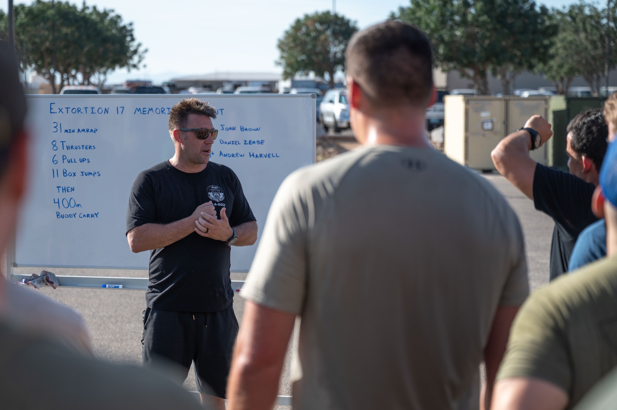 U.S. Air Force Chief Master Sergeant John Hatzidakis, 48th Rescue Squadron senior enlisted leader, speaks after a memorial workout at Davis-Monthan Air Force Base, August 6, 2025. Hatzidakis spoke about the fallen Airmen and their impact throughout the rescue community. (U.S. Air Force photo by Airman Jaden Kidd)