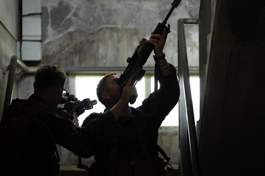 U.S. Marines with 2nd Battalion, 23rd Marines, forward deployed with 4th Marine Regiment, 3d Marine Division as part of the Unit Deployment Program, demonstrate how to clear a stairway during military operations in urban terrain training during the Korean Marine Exchange Program 25.2 in Pocheon, South Korea, July 22, 2025. KMEP is conducted regularly between the ROK and U.S. Marine Corps to increase their combined capabilities through realistic training geared towards deterring threats and maintaining peace in the Indo-Pacific. (U.S. Marine Corps photo by Lance Cpl. Van Hoang)