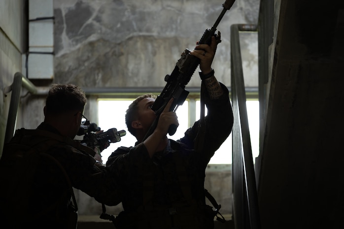 U.S. Marines with 2nd Battalion, 23rd Marines, forward deployed with 4th Marine Regiment, 3d Marine Division as part of the Unit Deployment Program, demonstrate how to clear a stairway during military operations in urban terrain training during the Korean Marine Exchange Program 25.2 in Pocheon, South Korea, July 22, 2025. KMEP is conducted regularly between the ROK and U.S. Marine Corps to increase their combined capabilities through realistic training geared towards deterring threats and maintaining peace in the Indo-Pacific. (U.S. Marine Corps photo by Lance Cpl. Van Hoang)