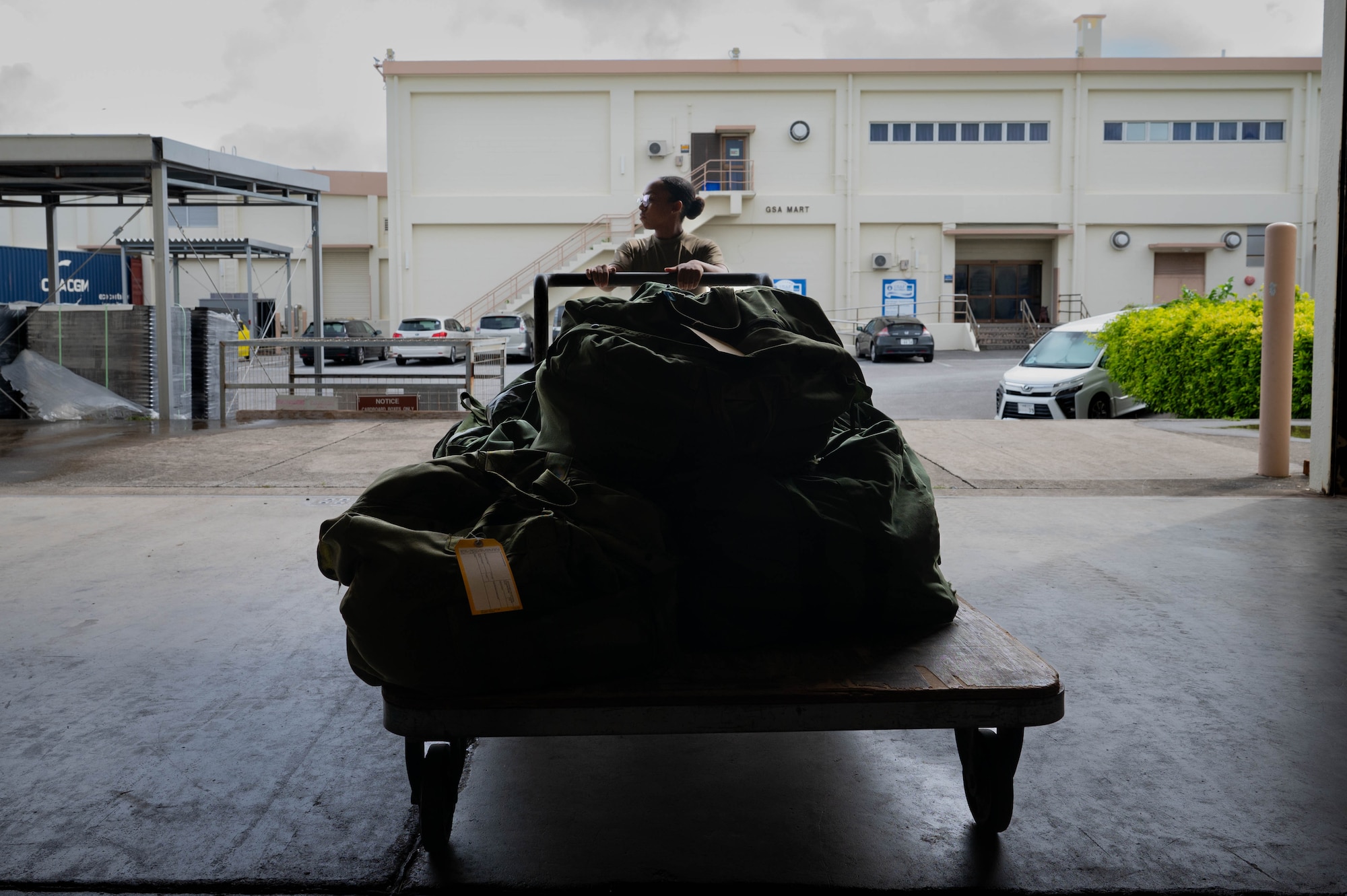 Airman rolls equipment bags.