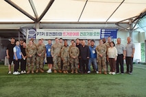 Volunteers from People to People International (PTPI), U.S. Soldiers from 2-23 Infantry Battalion, 1st Stryker Brigade Combat Team, 4th Infantry Division, and 210th Field Artillery Brigade pose for a group photo with local leaders in Pocheon, South Korea, Aug. 7, 2025. The joint effort supported a summer community event for senior citizens, reinforcing U.S.-ROK friendship through food, music, and shared service.