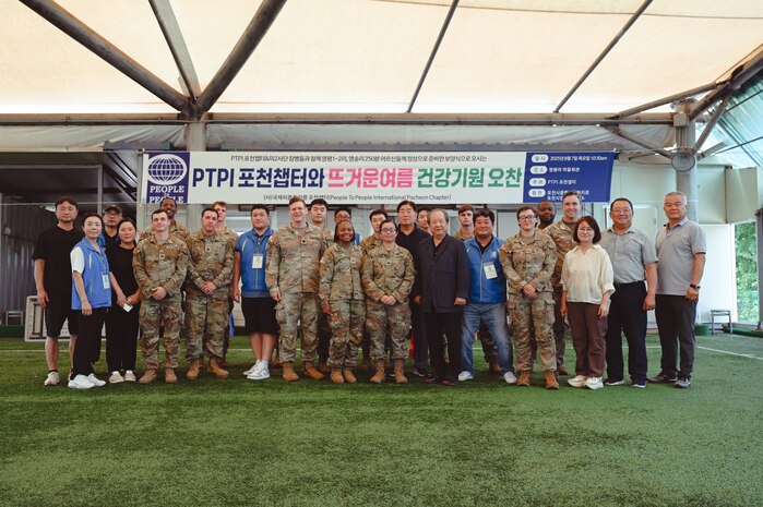 Volunteers from People to People International (PTPI), U.S. Soldiers from 2-23 Infantry Battalion, 1st Stryker Brigade Combat Team, 4th Infantry Division, and 210th Field Artillery Brigade pose for a group photo with local leaders in Pocheon, South Korea, Aug. 7, 2025. The joint effort supported a summer community event for senior citizens, reinforcing U.S.-ROK friendship through food, music, and shared service.