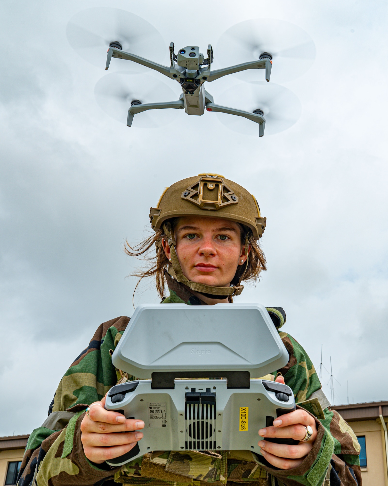 A drone hovers above an airman