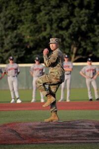 Col. Christopher Tung, G3, 85th U.S. Army Reserve Support Command, throws in a ceremonial first pitch, ahead of the week-long tournament, during the American Legion, Post 76, Great Lakes Regional Baseball Tournament, August 6, 2025, in Carol Stream, Illinois.