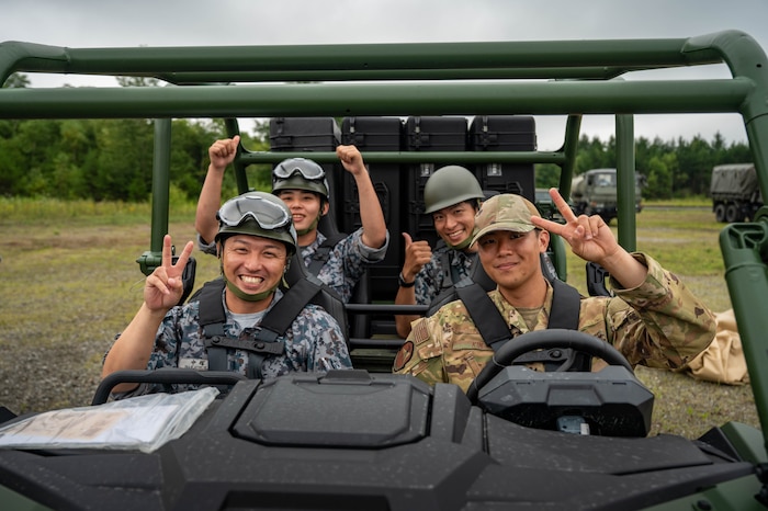 U.S. Air Force 2nd Lt. Nicholas Srajer, left, 35th Civil Engineer Squadron Design officer in charge, shovels debris alongside a Japan Air Self Defense Force airman assigned to the 2nd Air Wing during exercise Resolute Force Pacific 2025 while conducting Rapid Airfield Damage Repair (RADR) training at Chitose Air Base, Japan, July 29, 2025.