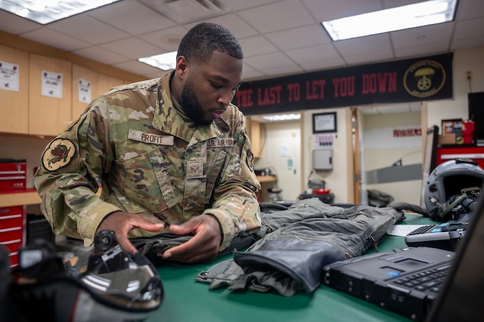 U.S. Air Force Senior Airman Tyreik Profit, 51st Operational Support Squadron aircrew flight equipment technician, inspects a flight suit at Osan Air Base, Republic of Korea, Aug. 5, 2025. Profit was responsible for the inspection, maintenance, fitting and repair of F-16 Fighting Falcon flight equipment used by all pilots assigned to the 51st Fighter Wing. (U.S. Air Force photo by Staff Sgt. Sarah Williams)