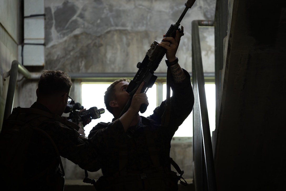 U.S. Marines with 2nd Battalion, 23rd Marines, forward deployed with 4th Marine Regiment, 3d Marine Division as part of the Unit Deployment Program, demonstrate how to clear a stairway during military operations in urban terrain training during the Korean Marine Exchange Program 25.2 in Pocheon, South Korea, July 22, 2025. KMEP is conducted regularly between the ROK and U.S. Marine Corps to increase their combined capabilities through realistic training geared towards deterring threats and maintaining peace in the Indo-Pacific. (U.S. Marine Corps photo by Lance Cpl. Van Hoang)