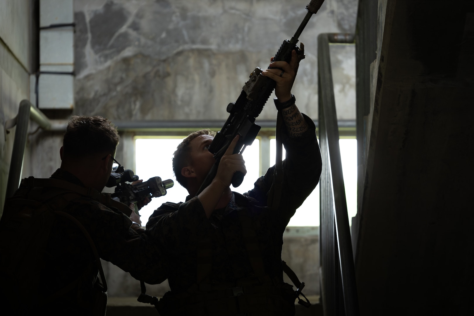 U.S. Marines with 2nd Battalion, 23rd Marines, forward deployed with 4th Marine Regiment, 3d Marine Division as part of the Unit Deployment Program, demonstrate how to clear a stairway during military operations in urban terrain training during the Korean Marine Exchange Program 25.2 in Pocheon, South Korea, July 22, 2025. KMEP is conducted regularly between the ROK and U.S. Marine Corps to increase their combined capabilities through realistic training geared towards deterring threats and maintaining peace in the Indo-Pacific. (U.S. Marine Corps photo by Lance Cpl. Van Hoang)