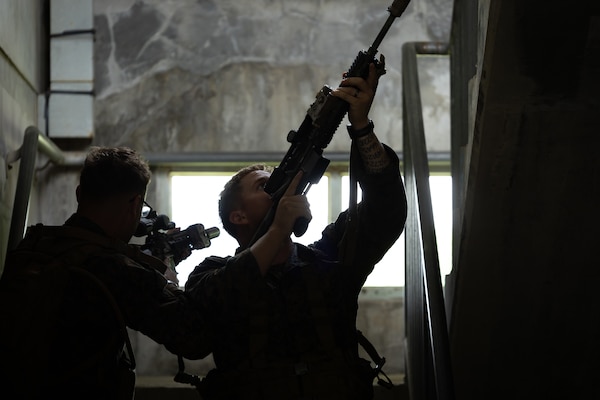 U.S. Marines with 2nd Battalion, 23rd Marines, forward deployed with 4th Marine Regiment, 3d Marine Division as part of the Unit Deployment Program, demonstrate how to clear a stairway during military operations in urban terrain training during the Korean Marine Exchange Program 25.2 in Pocheon, South Korea, July 22, 2025. KMEP is conducted regularly between the ROK and U.S. Marine Corps to increase their combined capabilities through realistic training geared towards deterring threats and maintaining peace in the Indo-Pacific. (U.S. Marine Corps photo by Lance Cpl. Van Hoang)
