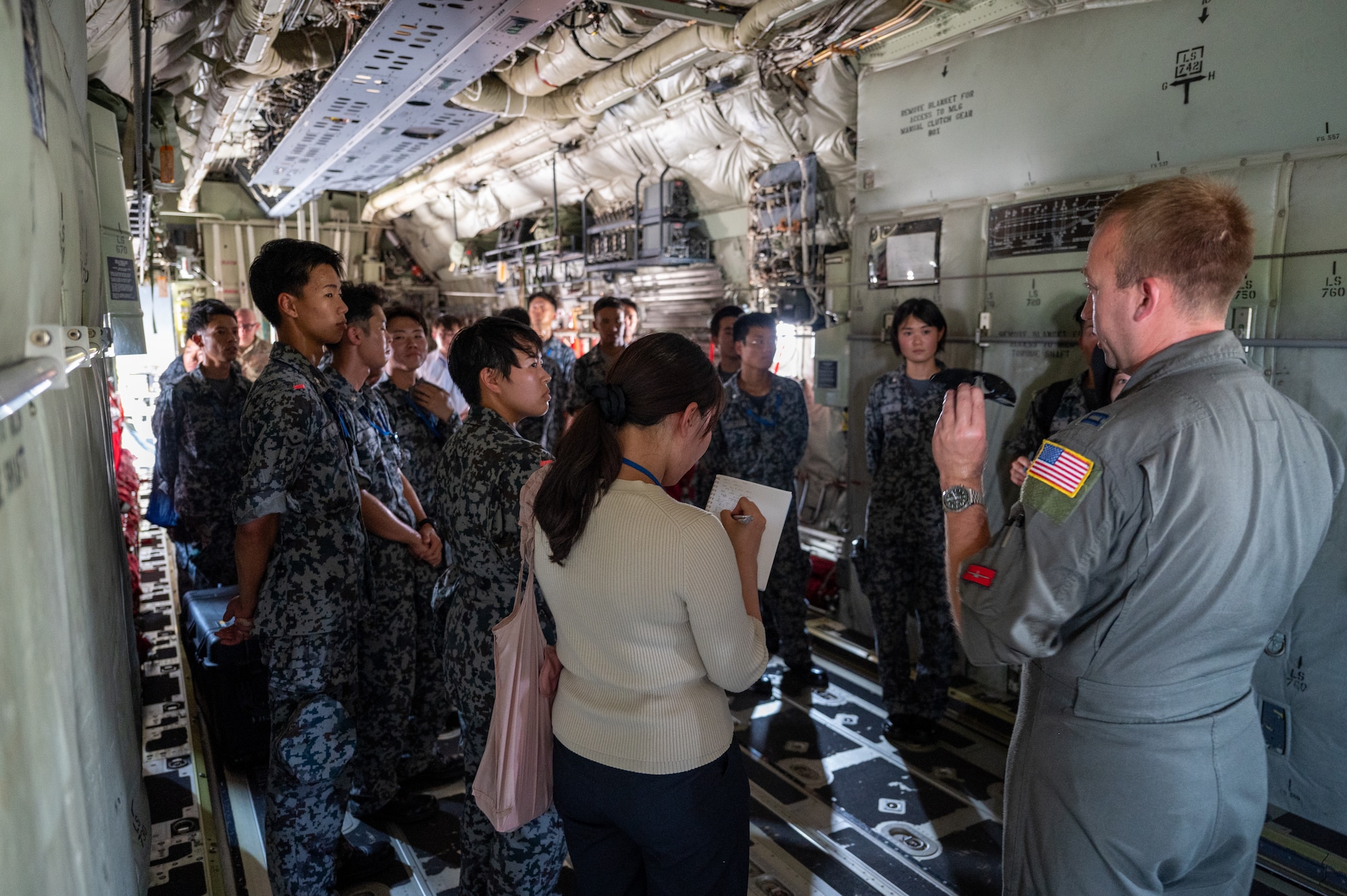 U.S. Air Force Capt. William Waller, 36th Airlift Squadron C-130J Super Hercules pilot, speaks to newly assigned members from the Japan Air Self-Defense Force Operations Support Wing and Air Intelligence Wing during a static display tour of a C-130J at Yokota Air Base, Japan.
