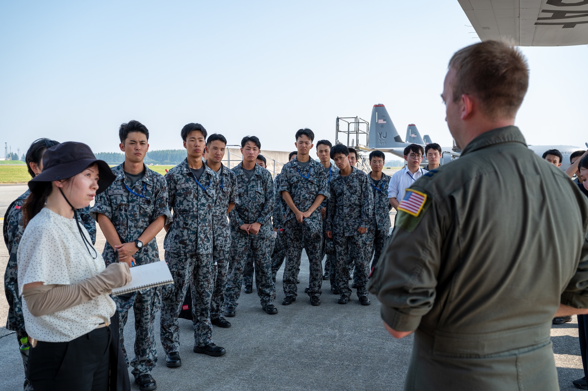 U.S. Air Force Capt. William Waller, 36th Airlift Squadron C-130J Super Hercules pilot, speaks to newly assigned members from the Japan Air Self-Defense Force Operations Support Wing and Air Intelligence Wing during a static display tour of a C-130J at Yokota Air Base, Japan.