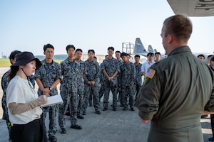 U.S. Air Force Capt. William Waller, 36th Airlift Squadron C-130J Super Hercules pilot, speaks to newly assigned members from the Japan Air Self-Defense Force Operations Support Wing and Air Intelligence Wing during a static display tour of a C-130J at Yokota Air Base, Japan.