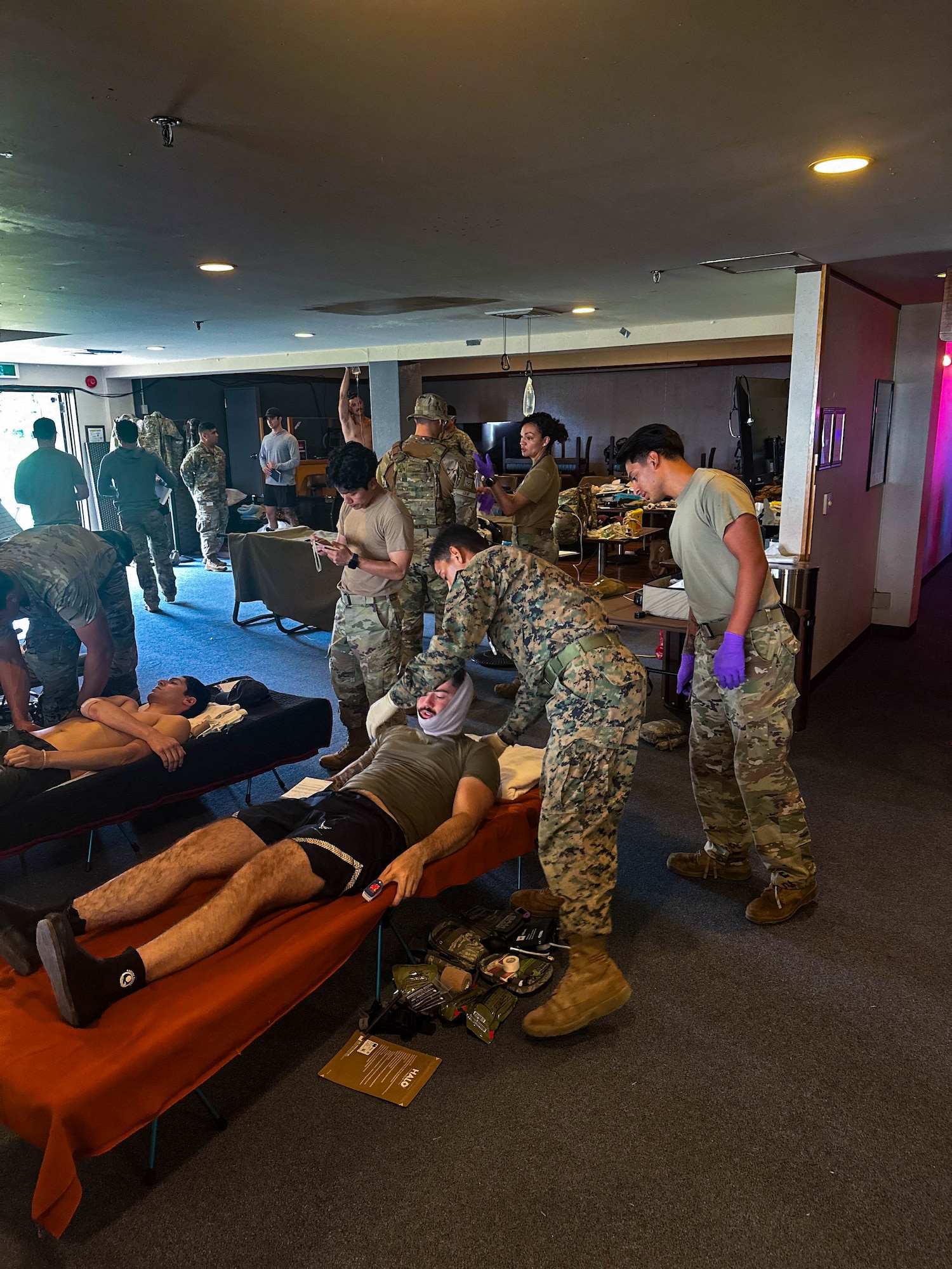 Service members treating simulated patients.