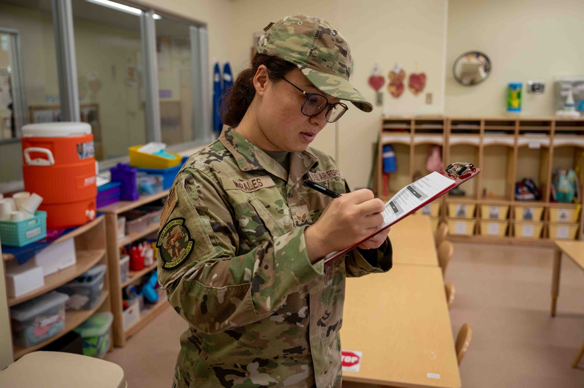 U.S. Air Force Senior Airman Reina Morales, 18th Operational Medical Readiness Squadron public health technician, fills out the quality control sheet during a routine facility inspection at the Wakaba Child Daycare Center on Kadena Air Base, Japan, Aug. 4, 2025.