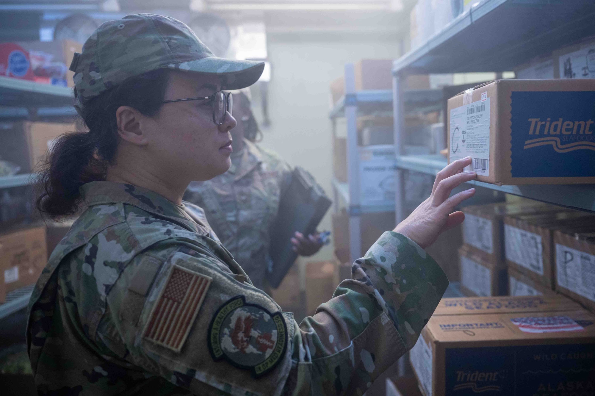U.S. Air Force Senior Airman Reina Morales, 18th Operational Medical Readiness Squadron public health technician, checks for the date of expiration on a box in the freezer on Kadena Air Base, Japan, Aug. 4, 2025.