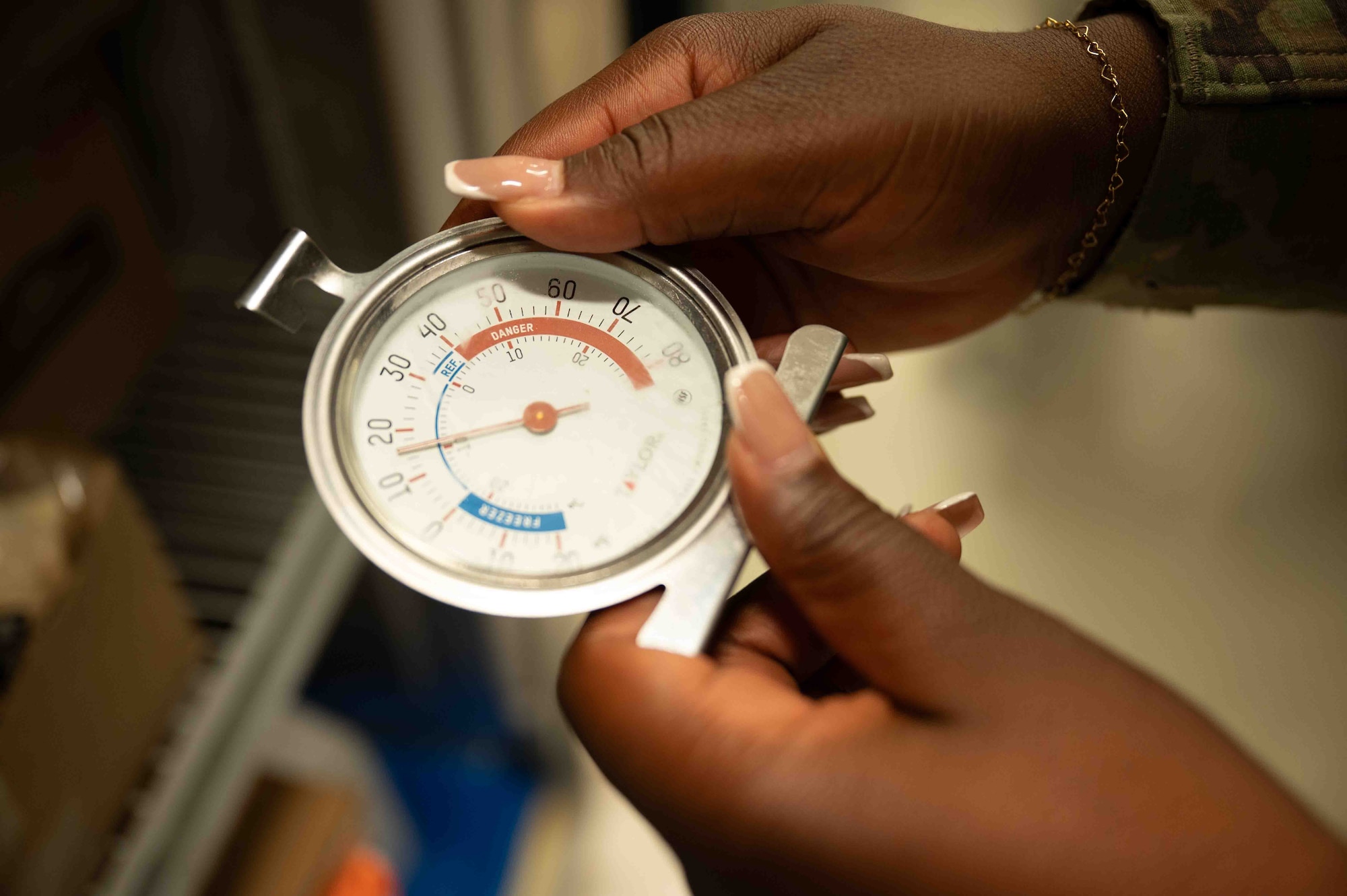 U.S. Air Force Staff Sgt. Afua Kwenua Dwiredu Gyamera, 18th Operational Medical Readiness Squadron non-commissioned officer in charge for community health, checks fridge thermometer on Kadena Air Base, Japan, Aug. 6, 2025.
