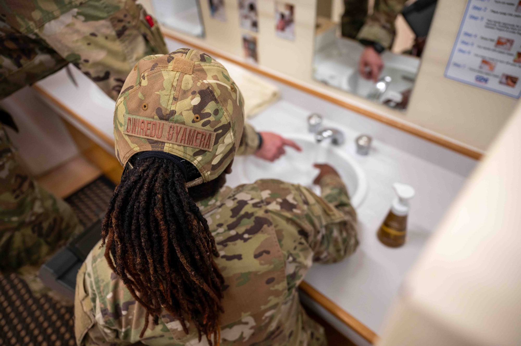 U.S. Air Force Staff Sgt. Afua Kwenua Dwiredu Gyamera, 18th Operational Medical Readiness Squadron non-commissioned officer in charge of community health, tests water temperature at the Wakaba Child Development Center during a routine facility inspection on Kadena Air Base, Japan, Aug. 4, 2025.