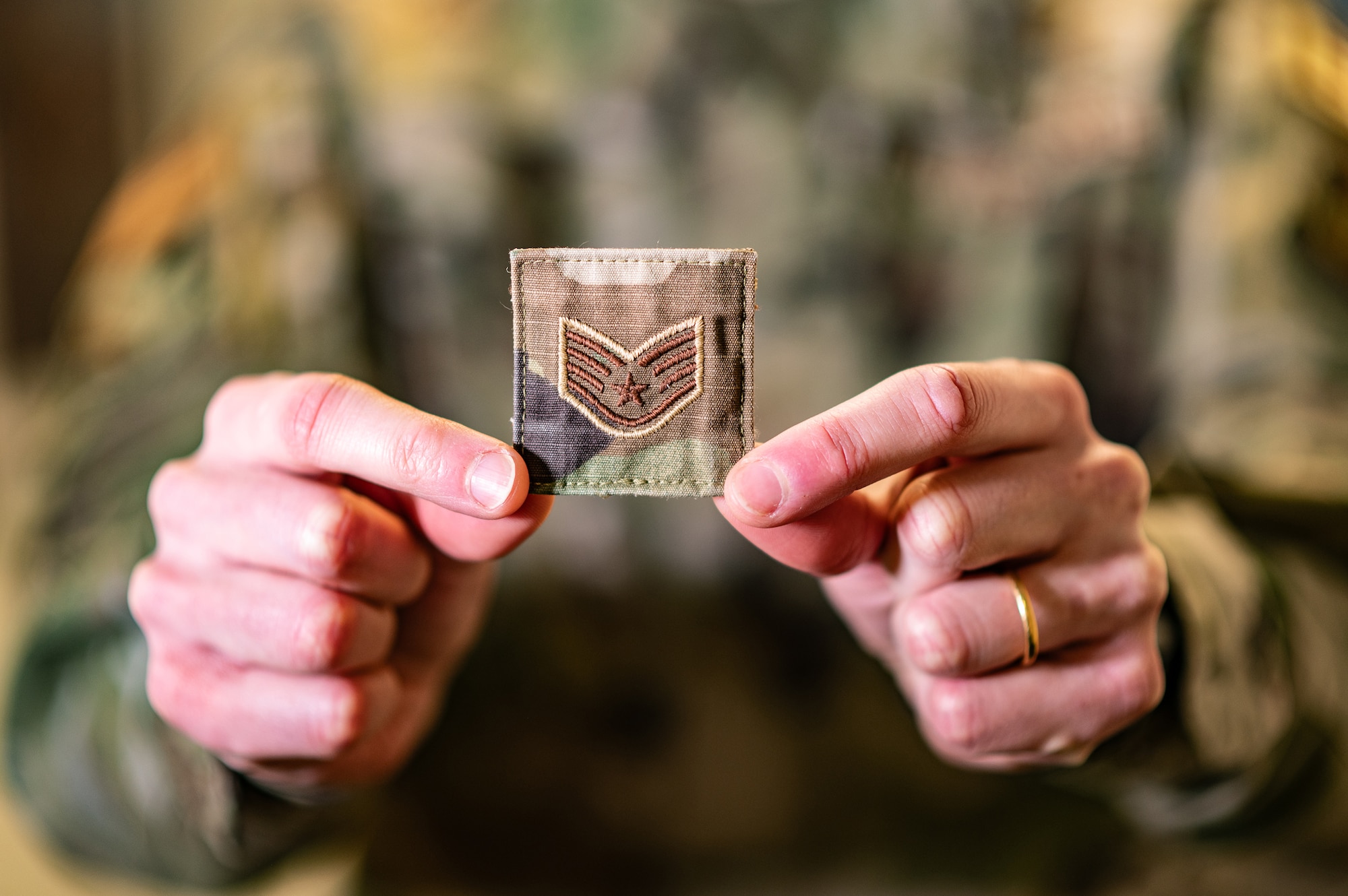 Image of person holding Air Force rank stripe.