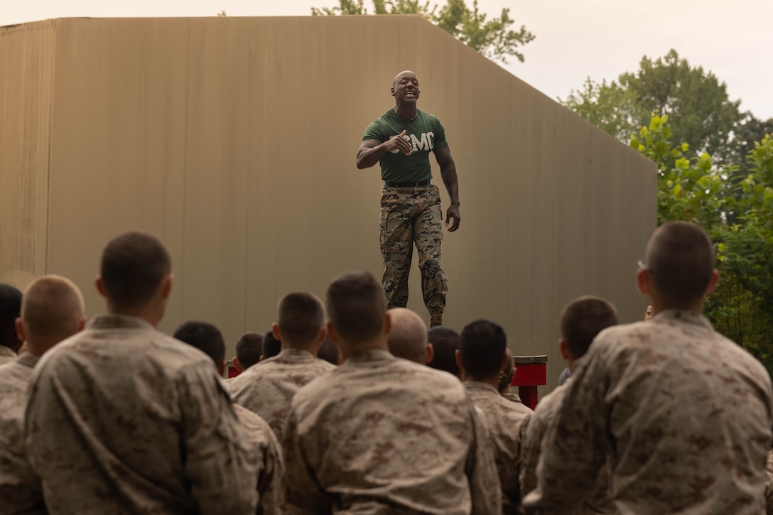 U.S. Marine Corps Gunnery Sgt. Wille Matlock, a physical training instructor at the Officer Candidate School, gives a speech before candidates conduct the Montford Point Challenge at OCS on Marine Corps Base Quantico, Virginia, Aug. 5, 2025. Candidates, sergeant instructors, and physical training instructors completed the course in honor of the Montford Point Marines who were the first African Americans to enlist in the U.S. Marine Corps and further instilled the corps‘ warfighting mentality. (U.S. Marine Corps photo by Lance Cpl. Harleigh Faulk)