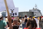 Families welcome the Independence-variant littoral combat ship USS Savannah (LCS 28) as it returns to Naval Base San Diego, Aug. 7, 2025. The Savannah returns to its homeport of San Diego following a 12-month rotational deployment to the U.S. 3rd and 7th Fleets. The Savannah operates with a dual crew, allowing the hull to stay in theater for longer durations. Littoral combat ships are fast, optimally manned, mission-tailored surface combatants that operate in near-shore and open-ocean environments, winning against 21st-century threats. LCSs integrate with joint, combined, manned and unmanned teams to support forward presence, maritime security, sea control, and deterrence missions around the globe. (U.S. Navy photo by Mass Communication Specialist 2nd Class Kassandra Alanis)