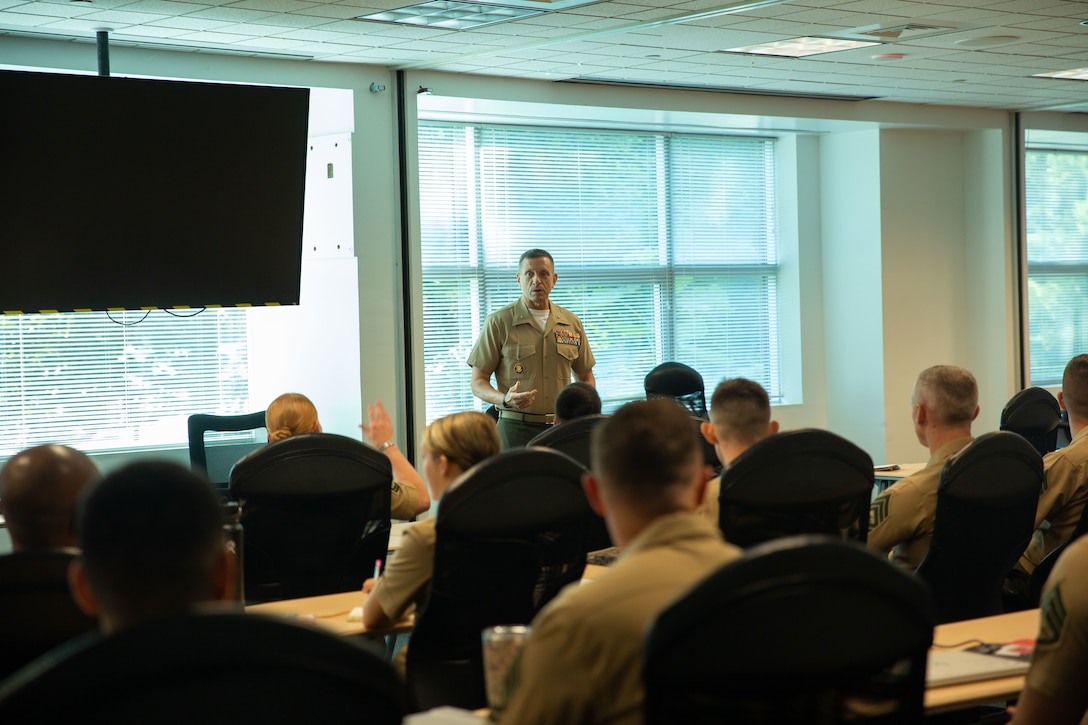 U.S Marine Corps Brig. Gen. Fridrik Fridriksson, director of manpower management, engages with new members of Manpower Management Enlisted Assignments (MMEA) attending Management Enlisted Assignments University (MMEA-U) as part of their onboarding process, Marine Corps Base Quantico, Virginia, July 25, 2025. MMEA-U is a weeklong course intended to help new monitors, career counselors, and support staff, implement the policies, procedures, and assignment processes necessary to ensure MMEA place the right Marine in the right billet at the right time.