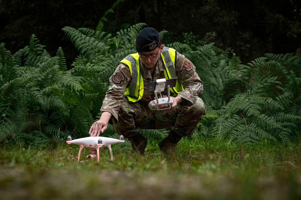U.S. Air Force Staff Sgt. Nathan Sands, 52nd Security Forces Squadron noncommissioned officer in charge of counter unmanned aircraft systems, prepares a drone during a joint UAS response exercise at Spangdahlem Air Base, Germany, July 29, 2025. Counter unmanned aircraft systems detect, identify, track and neutralize unauthorized drones to protect Air Force personnel, assets, and installations from aerial threats. (U.S. Air Force photo by Senior Airman Maria Umanzor Guzman)