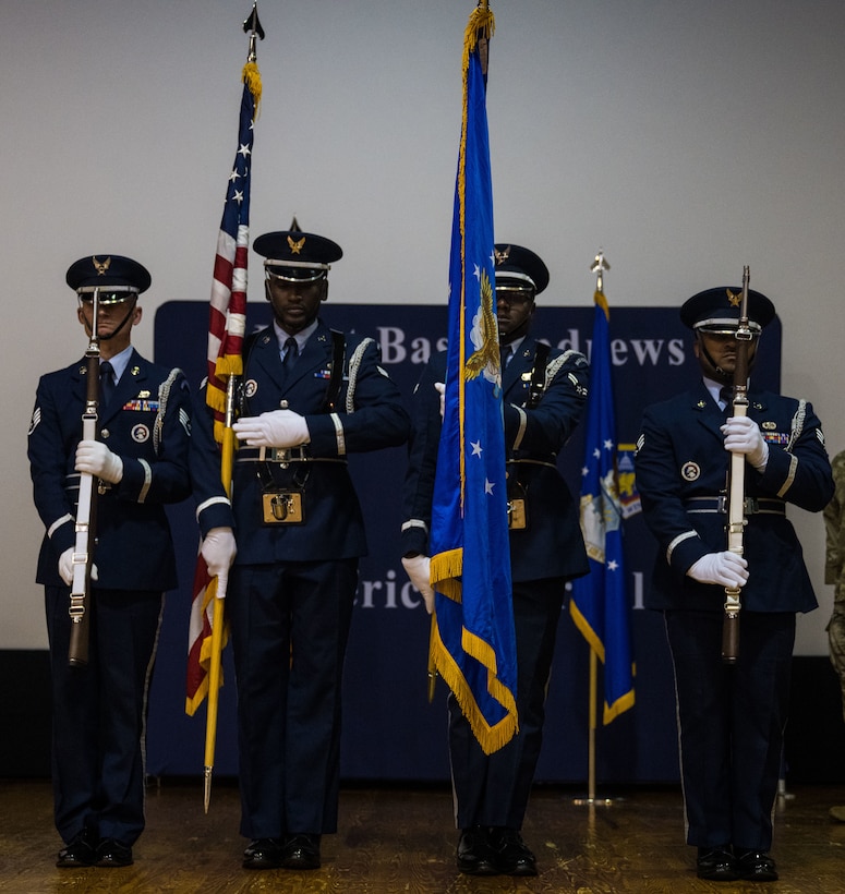 Joint Base Andrews Honor Guard members stand in formation presenting the colors during a retirement ceremony for Military Working Dogs Cchango and Nero at Joint Base Andrews, Md., Aug. 6, 2025.