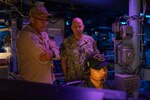 U.S. Navy Adm. James W. Kilby, Chief of Naval Operations (Acting) (center), speaks with Capt. Nathan Diaz, commanding officer of the Ticonderoga-class guided-missile cruiser USS Normandy (CG 60) aboard the USS Normandy during Large Scale Exercise (LSE) on August 5, 2025.
