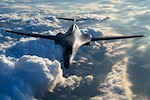 B1-B Lancer in flight surrounded by clouds