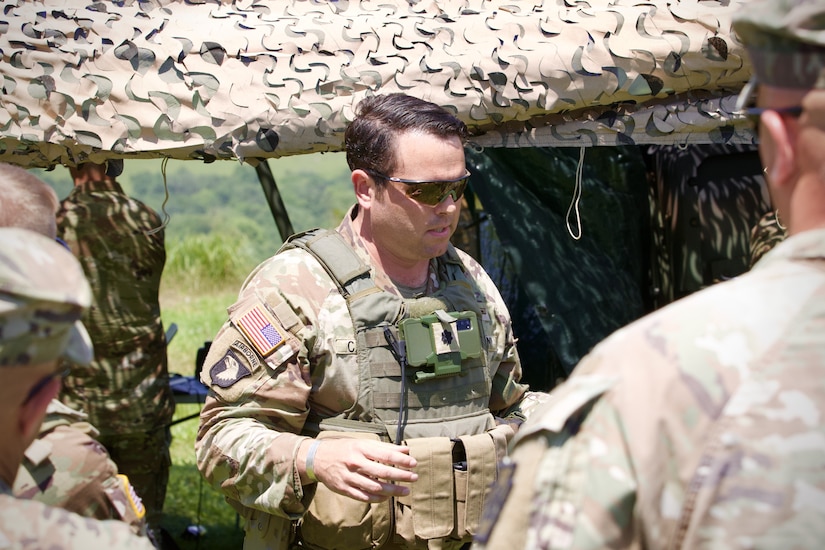 U.S. Army Lt. Col. David Caudle, commander of 1st Battalion, 109th Infantry Regiment, 2nd Infantry Brigade Combat Team, 28th Infantry Division, briefs observers during a demonstration at Fort Indiantown Gap, Pennsylvania, July 28, 2025. The Soldiers and representatives from Carnegie Mellon University’s Software Engineering Institute demonstrated Project Shrike, an AI-enabled system for rapid target recognition and fire adjustment, by integrating drones and artillery during live-fire training. (U.S. Army National Guard photo by Maj. Travis Mueller)