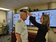 Capt. Jonathan Townsend is promoted to the rank of Rear Admiral in a ceremony on Aug. 7, 2025, with his family and some Navy Region Northwest staff in attendance.