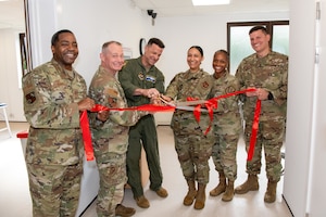 501st Combat Support Wing leaders and members of the 422nd Medical Squadron cut the ribbon to officially open the new medical aid station