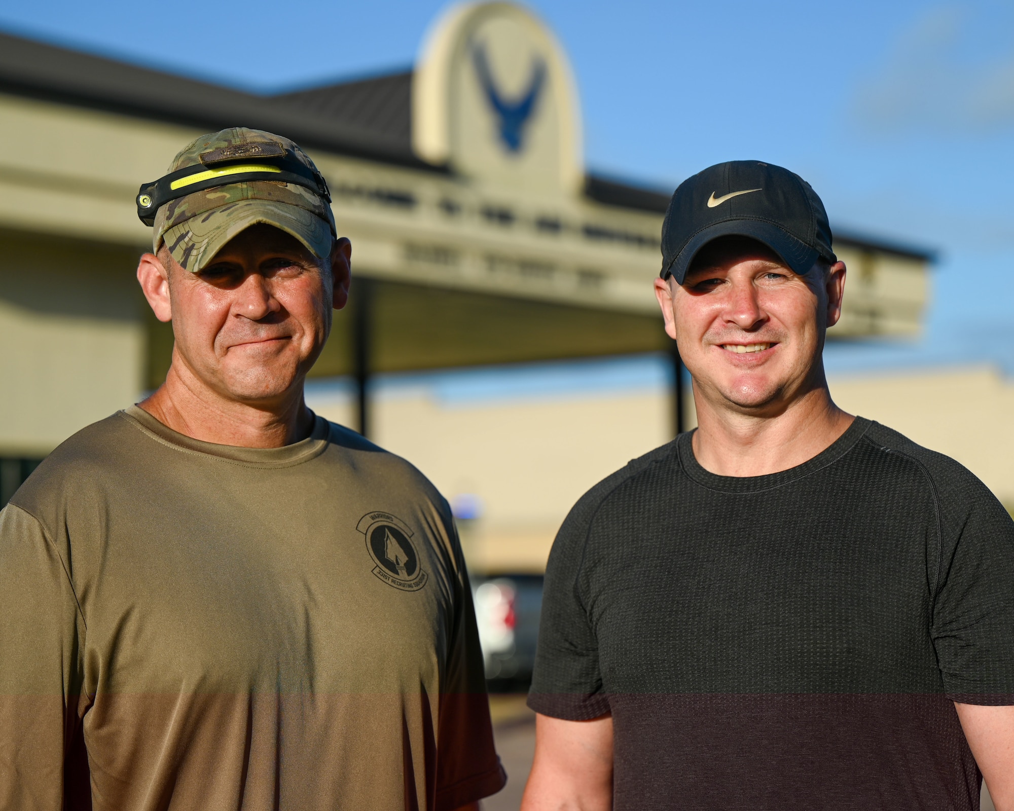 U.S. Air Force Chief Master Sgt. Trent Branstetter, left, 331st Recruiting Squadron senior enlisted leader, hikes into work alongside Capt. Bryan Berrio, right, 331st RCS operations flight commander, at Maxwell Air Force Base Gunter Annex, Alabama, July 25, 2025.
