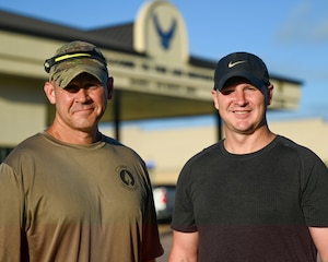 U.S. Air Force Chief Master Sgt. Trent Branstetter, left, 331st Recruiting Squadron senior enlisted leader, hikes into work alongside Capt. Bryan Berrio, right, 331st RCS operations flight commander, at Maxwell Air Force Base Gunter Annex, Alabama, July 25, 2025.