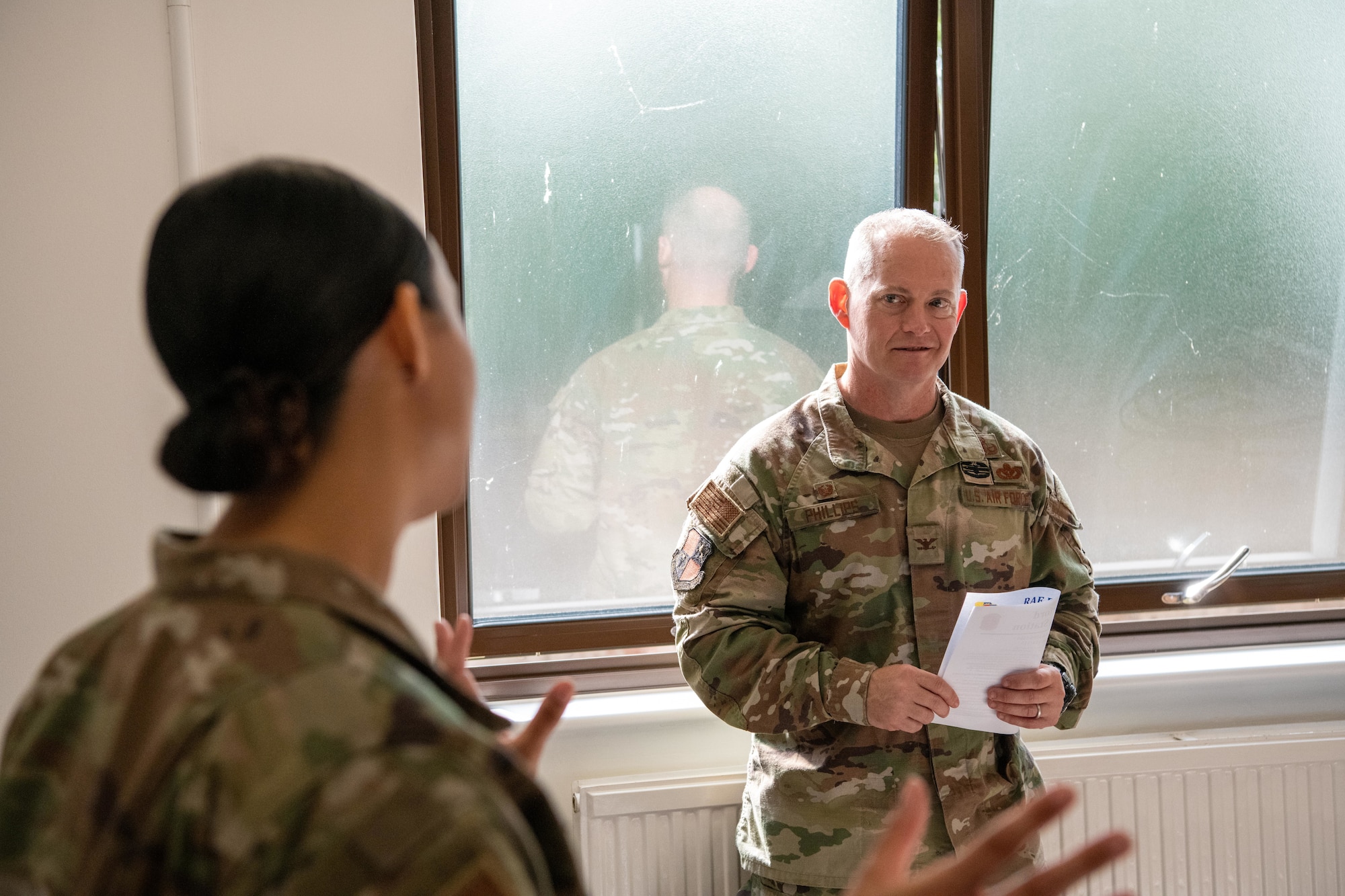 Col. D. Landon Phillips, then-501st Combat Support Wing commander, speaks with Tech. Sgt. Kirsty House, 422nd Medical Squadron medical operations flight chief, inside the new medical aid station