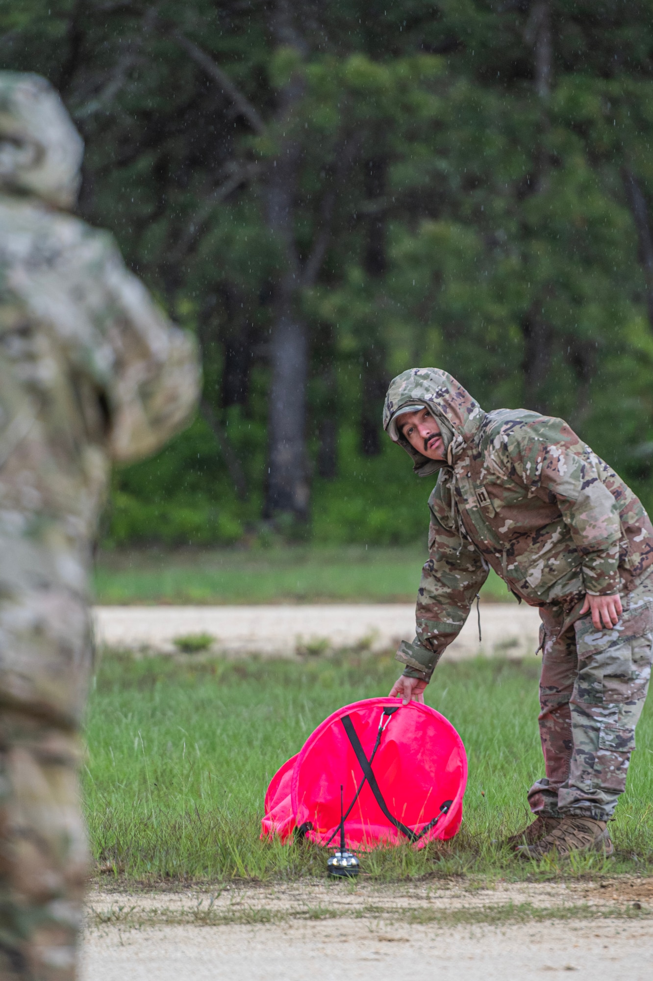 Airman places down a high-visibility marker panel