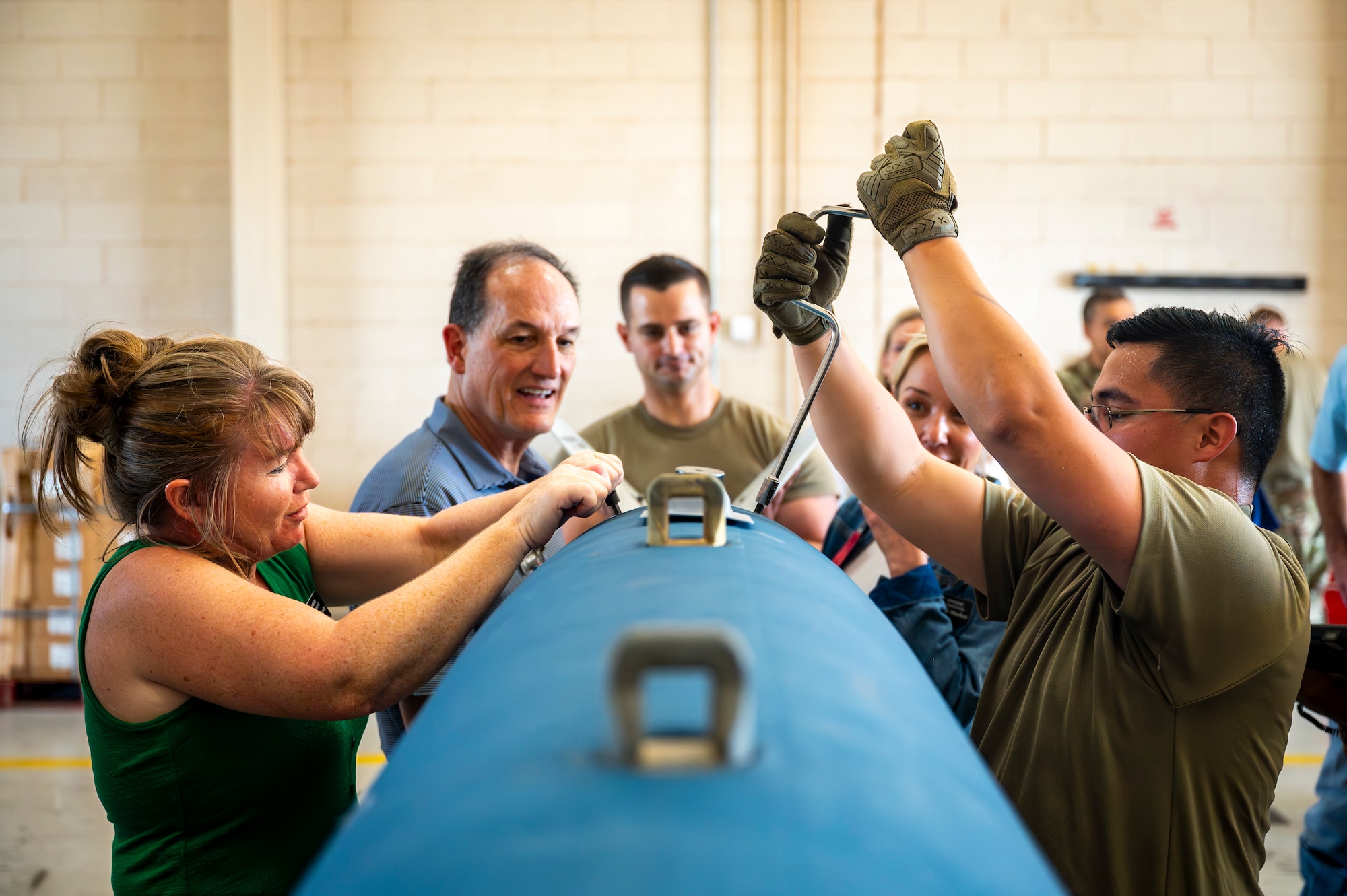 Honorary commanders from Goodfellow Air Force Base assemble a Joint Direct Attack Munition with assistance from 7th Munitions Squadron Airmen, during a tour at Dyess Air Force Base, Texas, Aug. 6, 2025. Dyess AFB hosted the Goodfellow honorary commanders to provide them with a hands-on experience showcasing some of Dyess’ operational missions sets and the capabilities of our Airmen. (U.S. Air Force photo by Staff Sgt. Leon Redfern)
