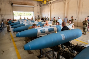 Honorary commanders from Dyess and Goodfellow Air Force Base assemble Joint Direct Attack Munitions with assistance from the 7th Munitions Squadron, during a tour at Dyess AFB, Texas, Aug. 6, 2025. The Dyess Honorary Commander program is an executive-level program intended to educate community members who have limited knowledge of the Air Force and Dyess to foster public support for the base and its Airmen and families. (U.S. Air Force photo by Staff Sgt. Leon Redfern)